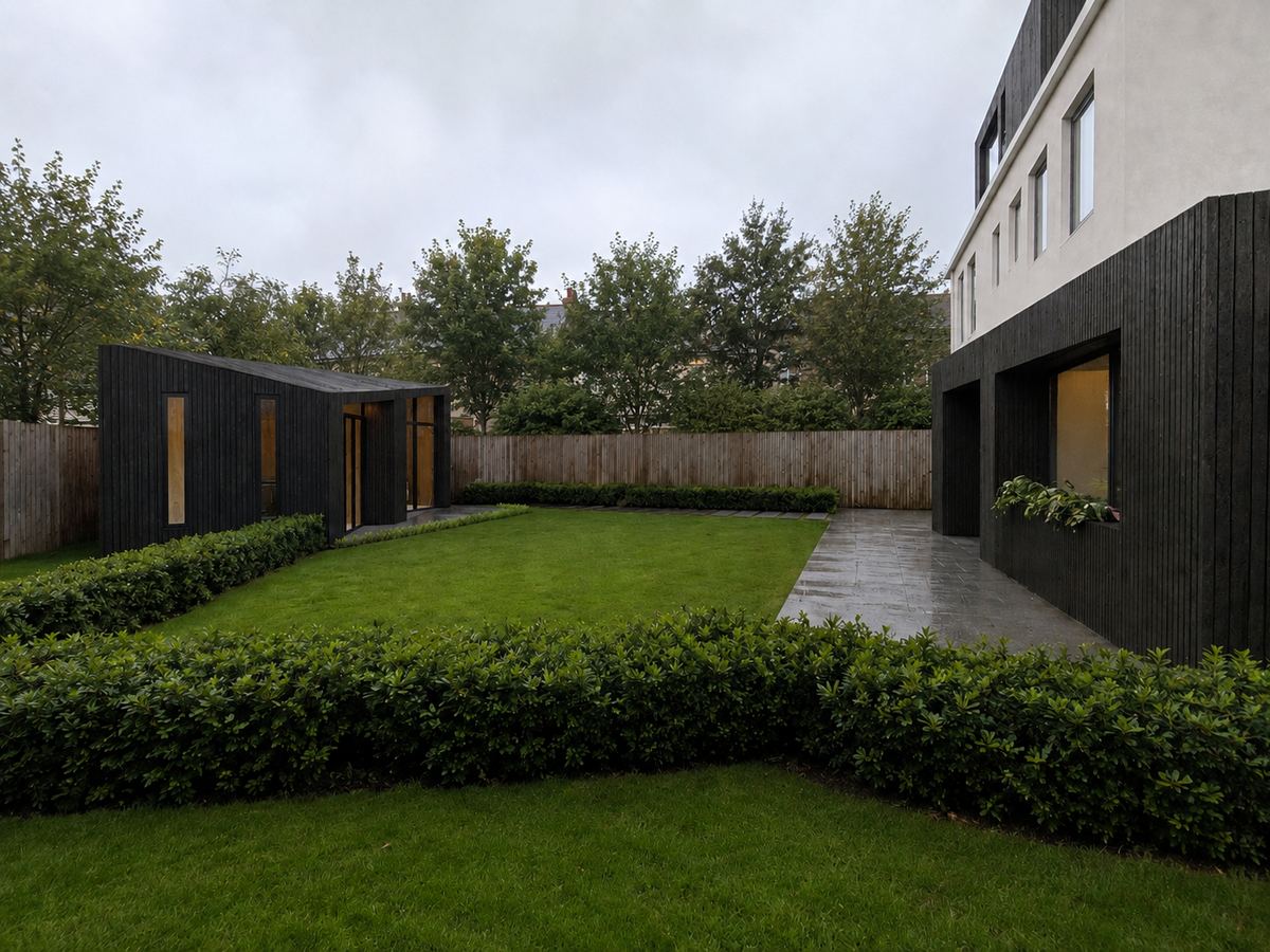 The completed extension and garden pod seen across the lawn on an overcast day