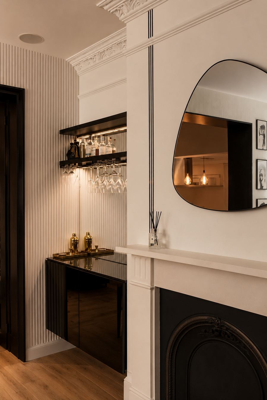 The completed dining room, with a bar recess in fluted panelling beside the retained fireplace