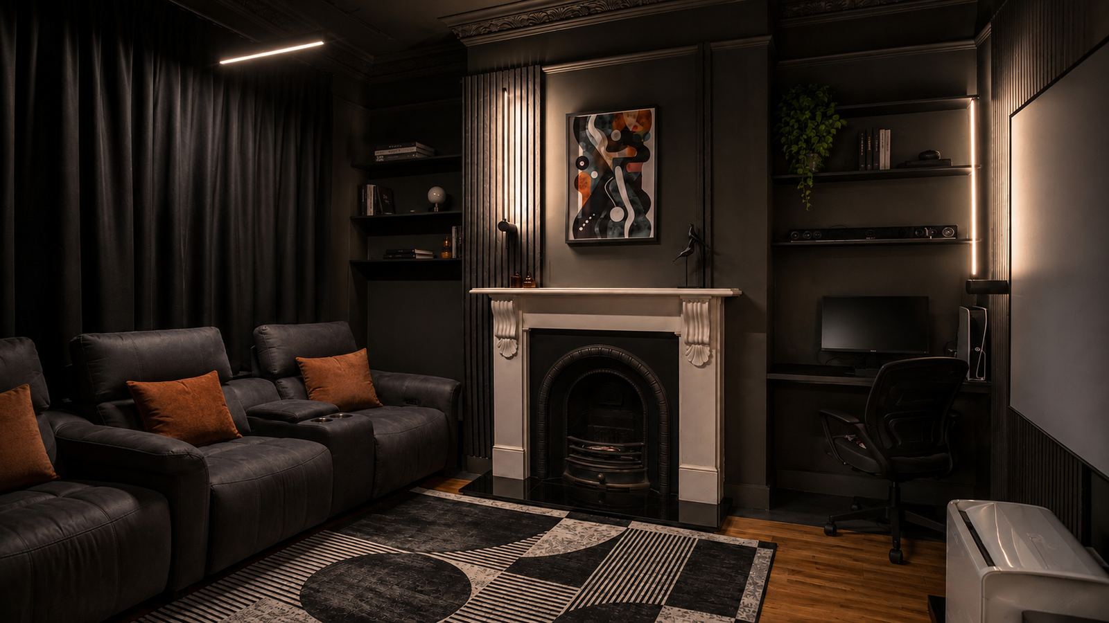 The completed media room in near-black, with reclining seating, a projection screen and a desk in the alcove