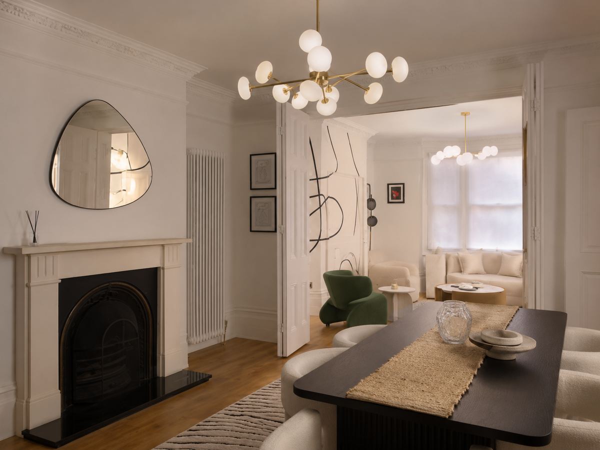 The completed dining room looking through open double doors to the living room beyond
