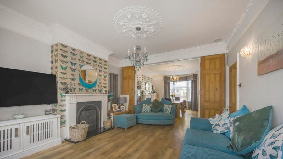 The two principal rooms as the house was marketed, looking from one through to the other past pine double doors