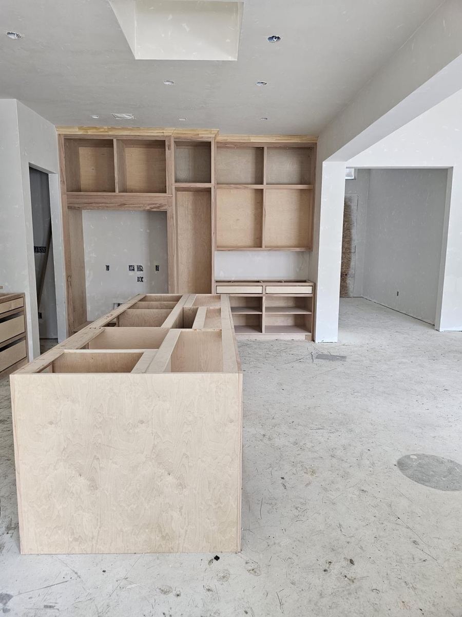The kitchen during construction, with joinery carcasses in place and services still exposed